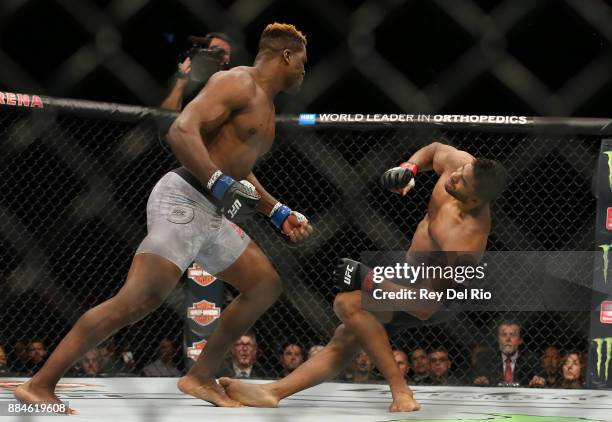 Francis Ngannou punches Alex Oliveira during the UFC 218 event at Little Caesars Arena on December 2, 2017 in Detroit, Michigan.