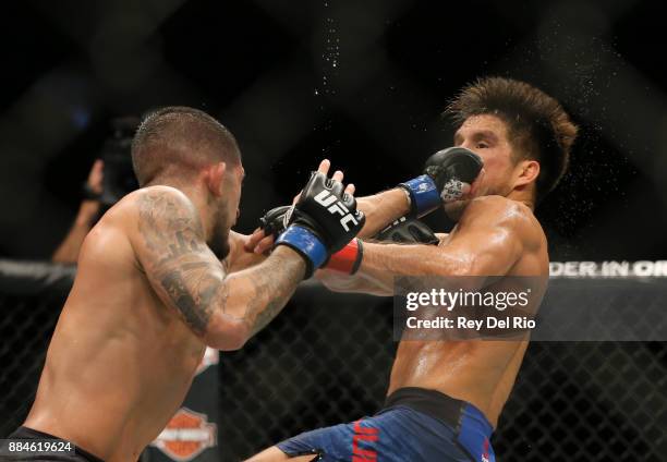 Sergio Pettis punches Henry Cejudo during the UFC 218 event at Little Caesars Arena on December 2, 2017 in Detroit, Michigan.