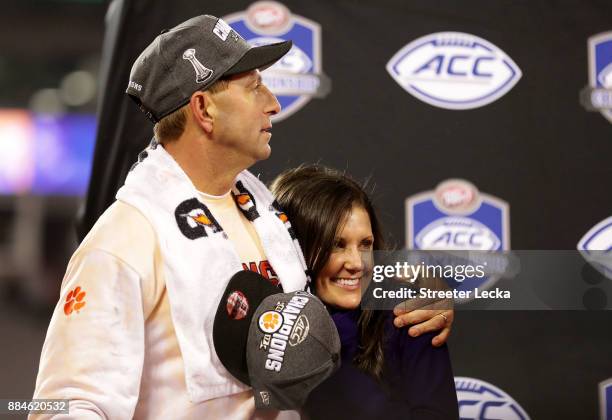 Head coach Dabo Swinney of the Clemson Tigers hugs his wife Kathleen Bassett during the trophy ceremony at the ACC Football Championship at Bank of...