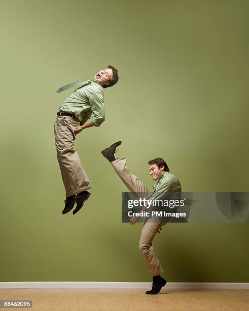 businessman kicks himself - bottom stock pictures, royalty-free photos & images