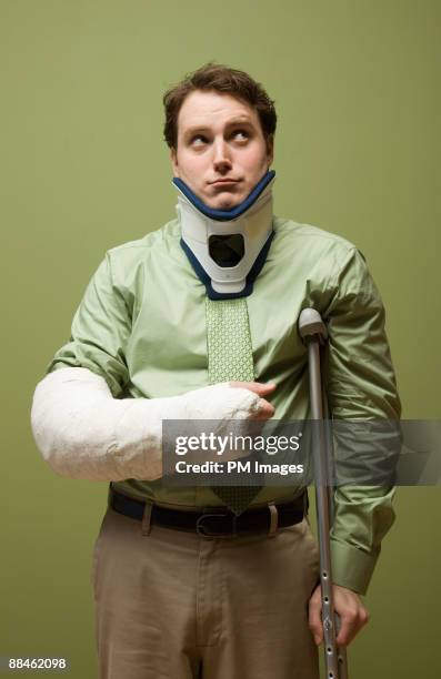 injured businessman - man crutches stock pictures, royalty-free photos & images