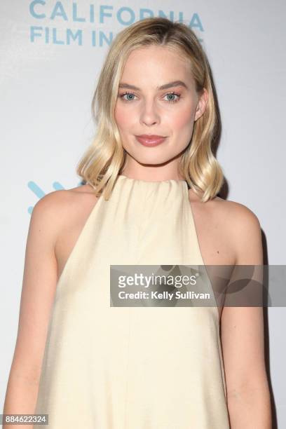 Actress Margot Robbie poses for photos on the red carpet for a premiere of "I, Tonya" at the Christopher B. Smith Rafael Film Center on December 2,...