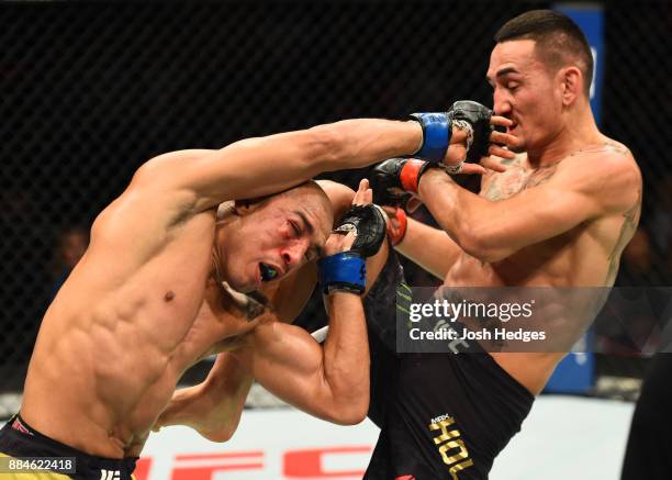 Max Holloway lands a knee against Jose Aldo of Brazil in their UFC featherweight championship bout during the UFC 218 event inside Little Caesars...