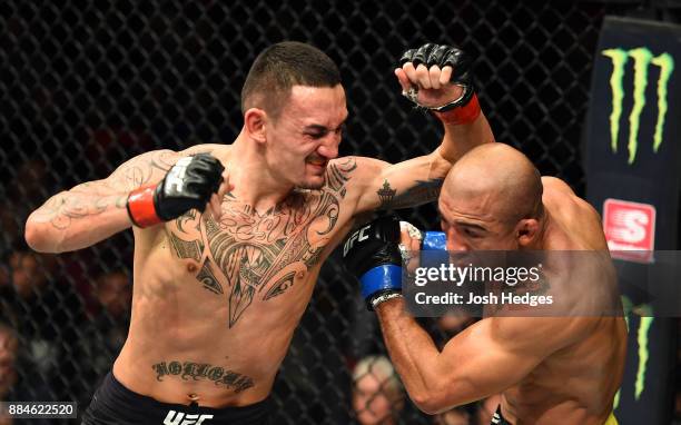 Max Holloway throws an elbow against Jose Aldo of Brazil in their UFC featherweight championship bout during the UFC 218 event inside Little Caesars...
