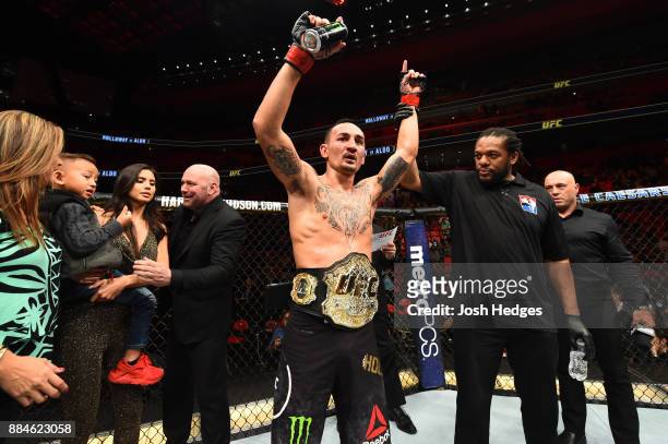 Featherweight champion Max Holloway celebrates after defeating Jose Aldo of Brazil in their UFC featherweight championship bout during the UFC 218...