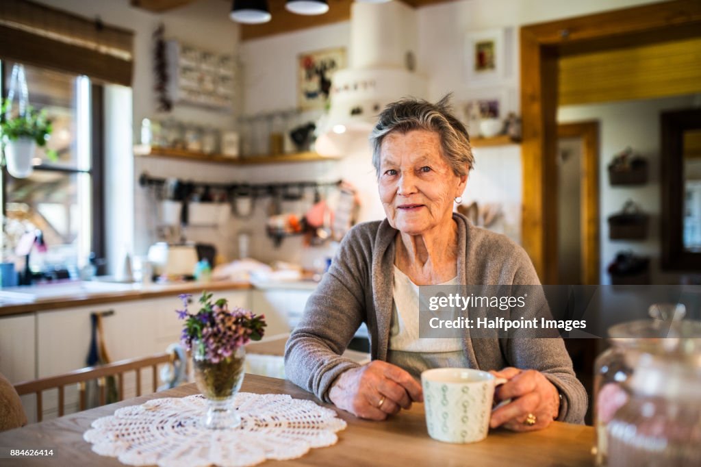 Grandmother at home drinking tea.