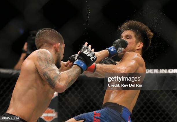 Sergio Pettis punches Henry Cejudo during the UFC 218 event at Little Caesars Arena on December 2, 2017 in Detroit, Michigan.