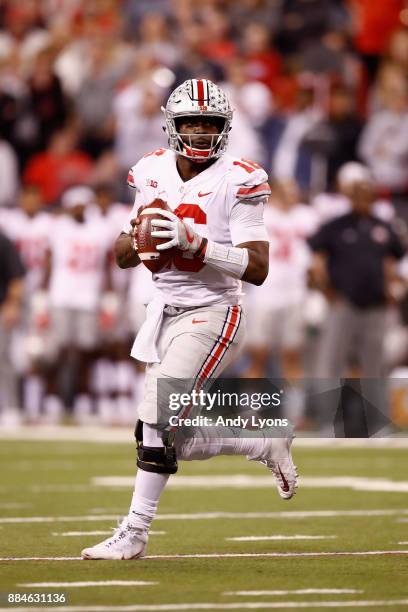 Quarterback J.T. Barrett of the Ohio State Buckeyes runs the ball against the Wisconsin Badgers during the Big Ten Championship game at Lucas Oil...