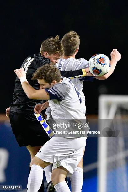 Henrik Roesholt of North Park University battles Colby Thomas of Messiah College during the Division III Men's Soccer Championship held at UNC...