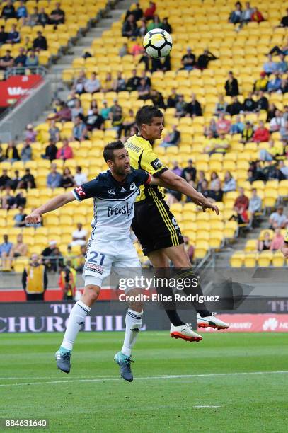 Carl Valeri of Melbourne Victory and Andrija Kaluderovic of the Wellington Phoenix contest the high ball during the round nine A-League match between...