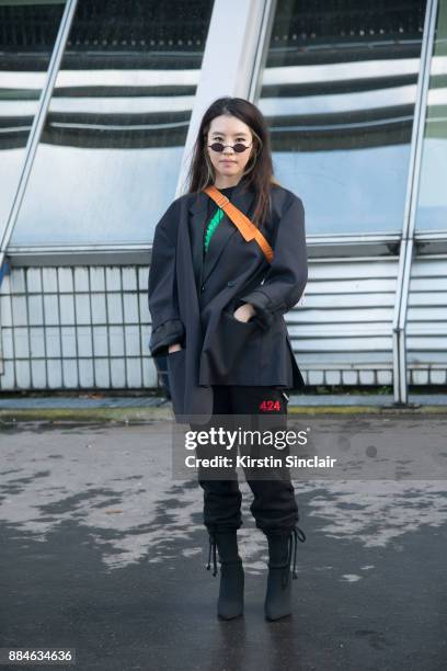 Senior digital Editor at Vogue Korea Hong Guk Hwa wears a Heron Preston bag, Roberi & Fraud sunglasses, Zara boots and Portable trousers day 5 of...
