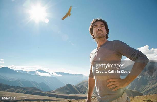 mature man in andean scenery, condors flying - salta provincie stockfoto's en -beelden