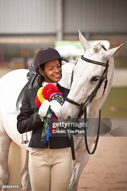 female horse rider with winners rosettes. - dressage stockfoto's en -beelden