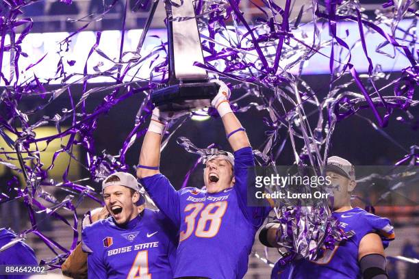 Linebacker Leighton Vander Esch and quarterback Brett Rypien of the Boise State Broncos hoist the championship trophy at the conclusion of the...