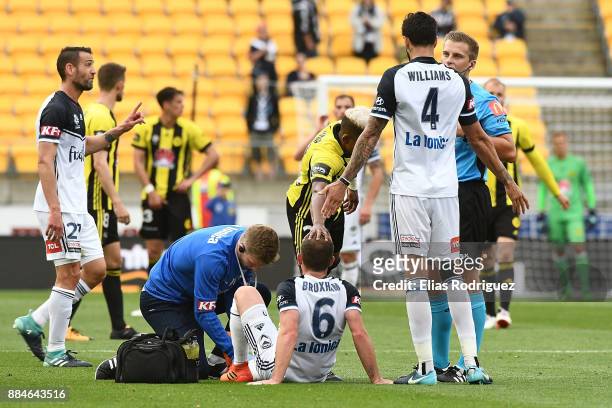 Leigh Broxham of Melbourne Victory receives medical attention during the round nine A-League match between the Wellington Phoenix and the Melbourne...