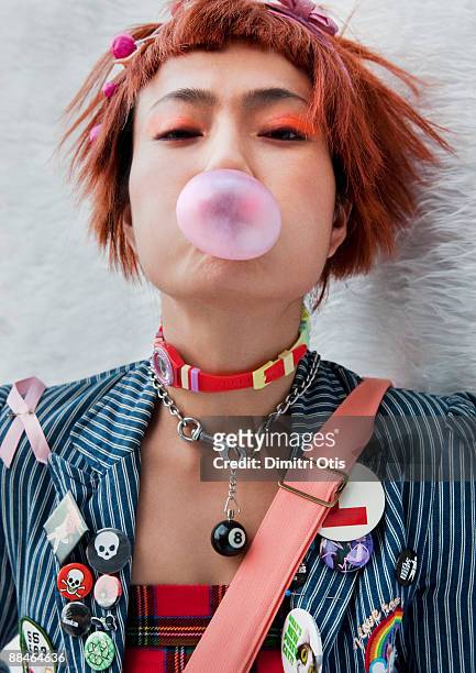 accessorised asian woman blowing a bubble - punkt stock pictures, royalty-free photos & images