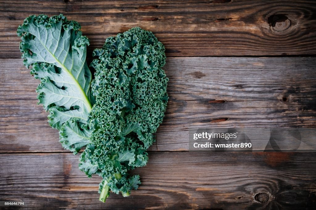 Fresh raw green superfood kale curly cabbage leaves