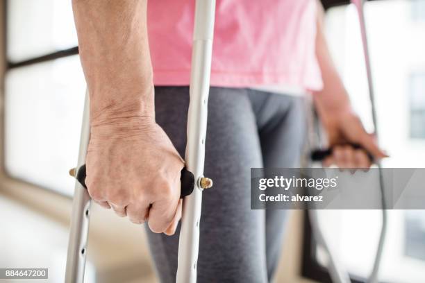 midsection of patient with crutches in hospital - crutch stock pictures, royalty-free photos & images