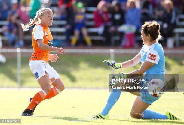 Tameka Butt of the Roar puts the ball past goal keeper Haley Kopmeyer of Cnaberra to score a goal during the round six W-League match between...