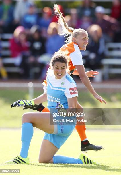 Tameka Butt of the Roar puts the ball past goal keeper Haley Kopmeyer of Cnaberra to score a goal during the round six W-League match between...