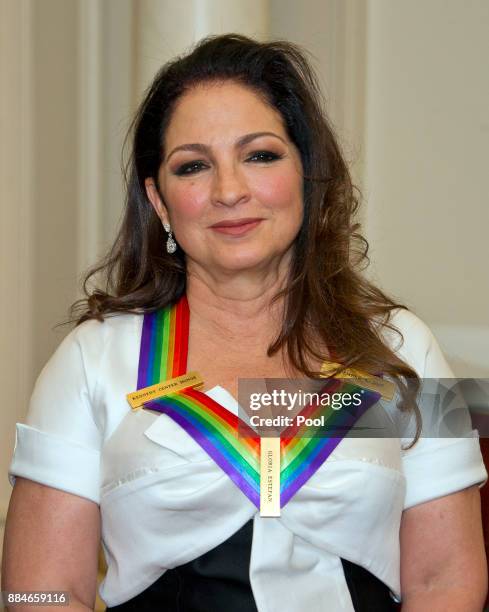 Gloria Estefan, one of he five recipients of the 40th Annual Kennedy Center Honors with her award as he poses for a group photo following a dinner...