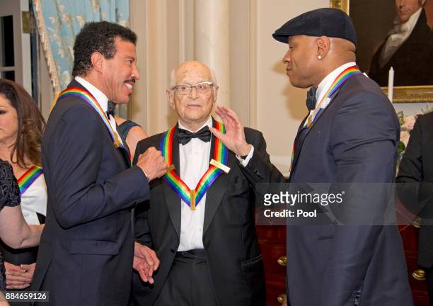 Lionel Richie, left, Norman Lear, center, and LL Cool J, right, three of the five recipients of the 40th Annual Kennedy Center Honors, converse prior...