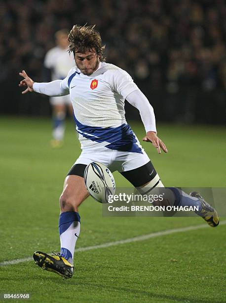 French player Maxime Medard clears the ball against New Zealand during their rugby union Test match at Carisbrook Stadium in Dunedin on June 13,...