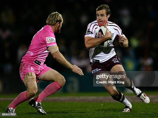 Michael Robertson of the Sea Eagles runs at Luke Walsh of the Panthers during the round 14 NRL match between the Penrith Panthers and the Manly...