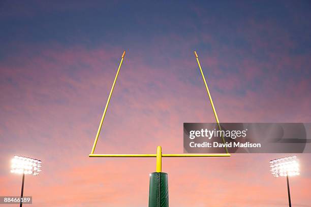 football goalpost and lights. - goal posts stockfoto's en -beelden