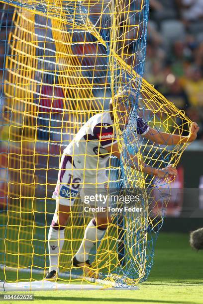 Joseph Mills of the Glory gets caught in the net during the round nine A-League match between the Central Coast Mariners and Perth Glory at Central...