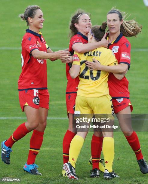 Goalkeeper Sarah Willacy of United is mobbed by teammates after saving a penalty attempt by Kyah Simon of the City during the round six W-League...