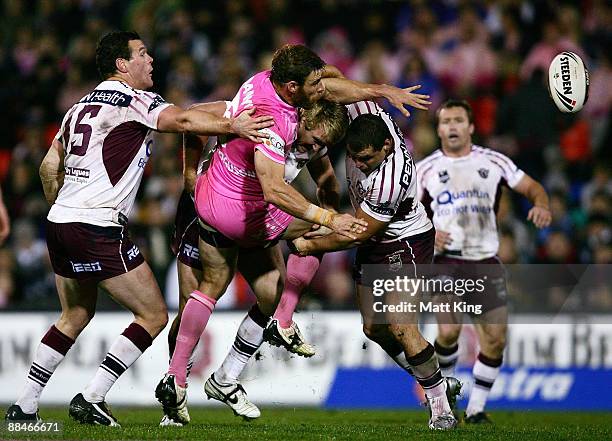 Shane Elford of the Panthers gets a pass away in a tackle during the round 14 NRL match between the Penrith Panthers and the Manly Warringah Sea...