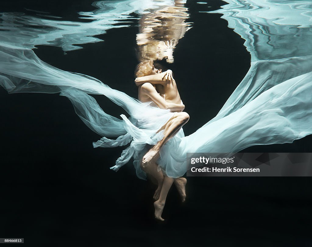 Young couple under water embracing