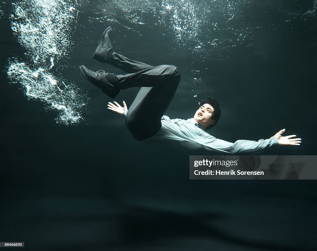 Businessman falling in water