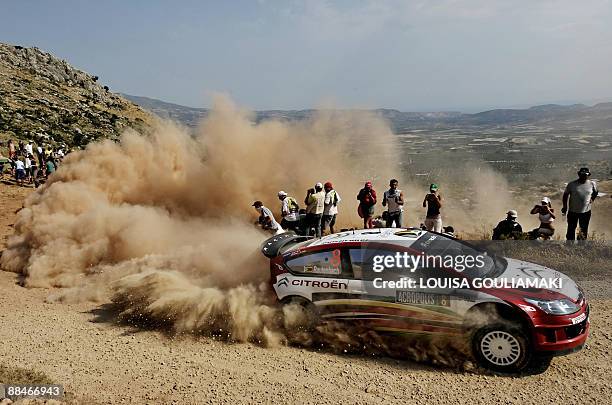 South African drivers Condrad Rautenbach and Daniel Barrit drive their Citroen C4 at Klenia-Mycenae on day two of the WRC Rally Acropolis near the...