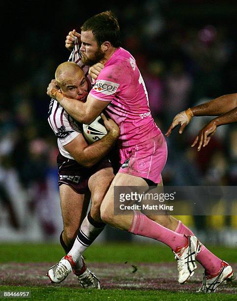 Glenn Stewart of the Sea Eagles is tackled by Gavin Cooper of the Panthers during the round 14 NRL match between the Penrith Panthers and the Manly...