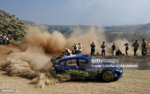 Norway's Mads Ostberg and Jonas Andersson of Sweden drive their Subaru Impreza at Klenia-Mycenae on day two of the WRC Rally Acropolis near the...