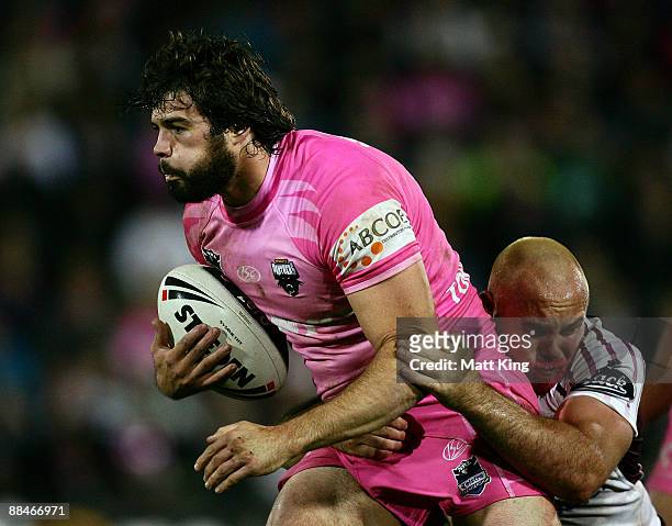 Matthew Bell of the Panthers is tackled by Glenn Stewart of the Sea Eagles during the round 14 NRL match between the Penrith Panthers and the Manly...