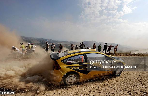 Russia's Evgeny Novikov and Dale Moscat drive their Citroen C4 at Klenia-Mycenae on day two of the WRC Rally Acropolis near the village of Agios...