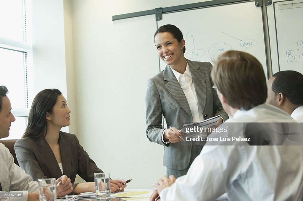 Businesswoman giving presentation in a board meeti