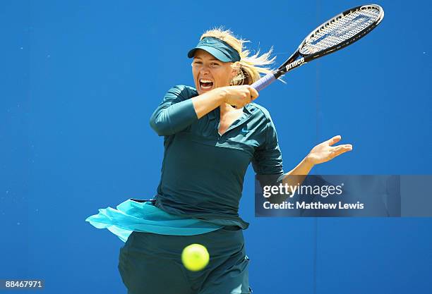 Maria Sharapova of Russia in action against Na Li of China during day Six of the AEGON Classic at the Edgbaston Priory Club on June 13, 2009 in...