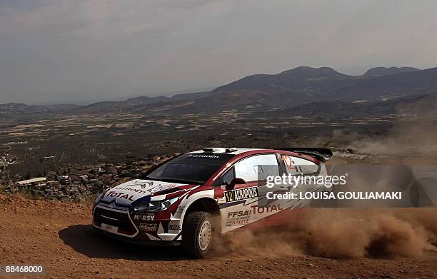 Frenchmen Sebastien Ogier and Julien Ingrassia drive their Citroen C4 at Klenia-Mycenae special stage on the day two of the WRC Rally Acropolis near...