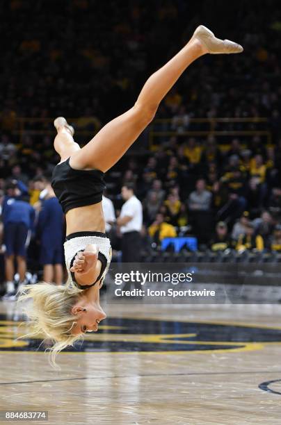 An Iowa cheerleader performs during a timeout during a Big Ten Conference basketball game between the Penn State Nittany Lions and the Iowa Hawkeyes...