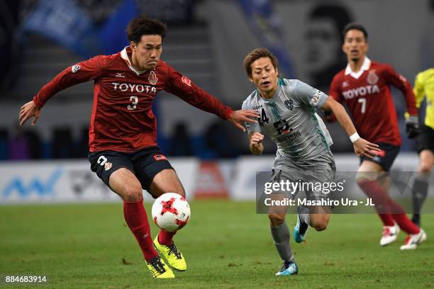Teruhito Nakagawa of Avispa Fukuoka and Kazuki Kushibiki of Nagoya Grampus compete for the ball during the J.League J1 Promotion Play-Off Final...