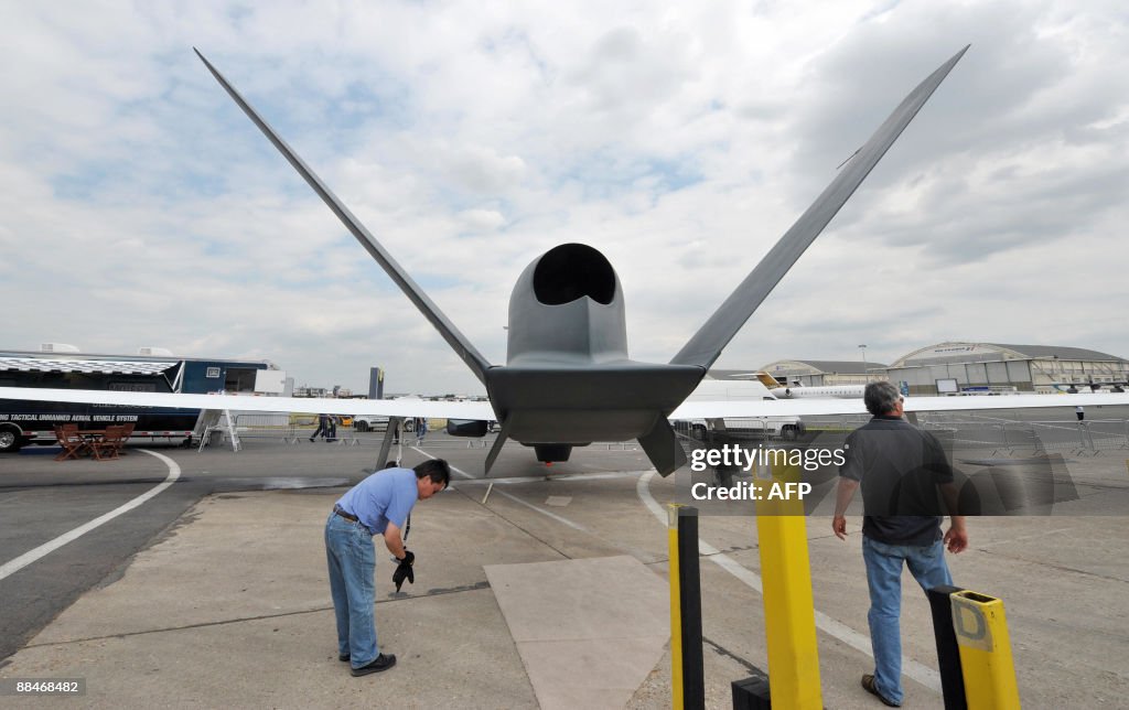 Staff members work in front of a scale m