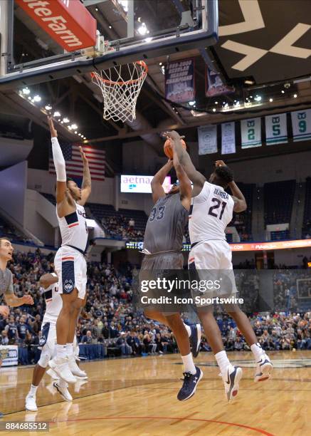 UConn Huskies Forward Mamadou Diarra blocks the shot attempt of Monmouth Hawks Guard Austin Tilghman during the game between the UConn Huskies and...