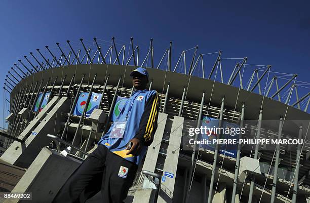 Volunteer walks in front of the Rustenburg's Royal Bafokeng Stadium on June 13, 2009. Spain will play New Zealand on June 14, 2009 in their first...