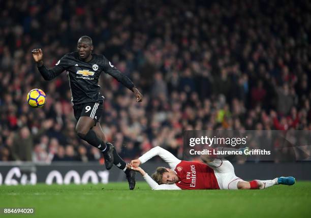 Romelu Lukaku of Manchester United gets tho the ball ahead of Nacho Monreal of Arsenal during the Premier League match between Arsenal and Manchester...