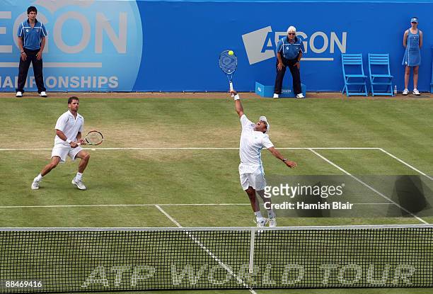 Jeff Coetzee of South Africa plays a smash playing with Jordan Kerr of Australia during the men's doubles semi final match against Marcelo Melo of...