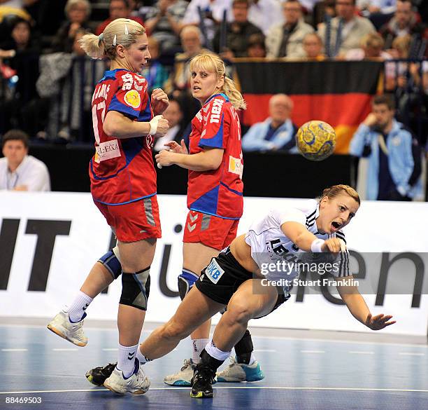 Ania Roesler of Germany is challenged by Sanja Rajovic and Slavica Koperec of Serbia during the Women's Handball World Championship qualification...
